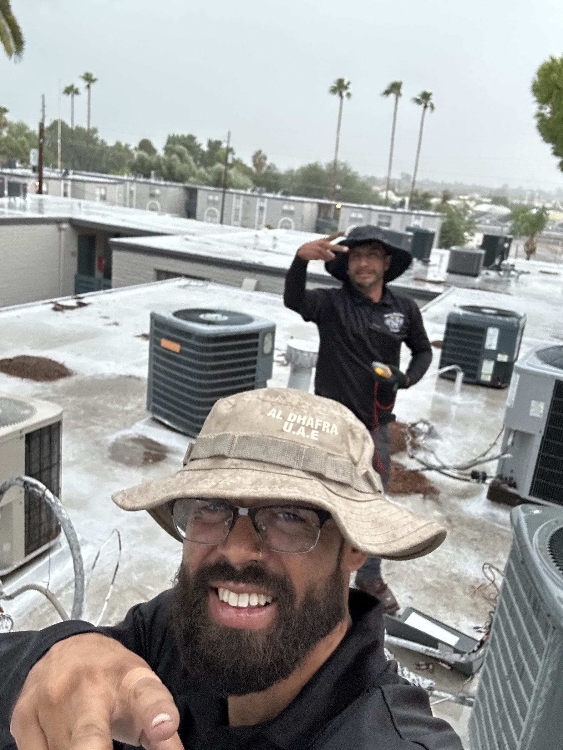 Victory Mechanical technicians on an apartment rooftop