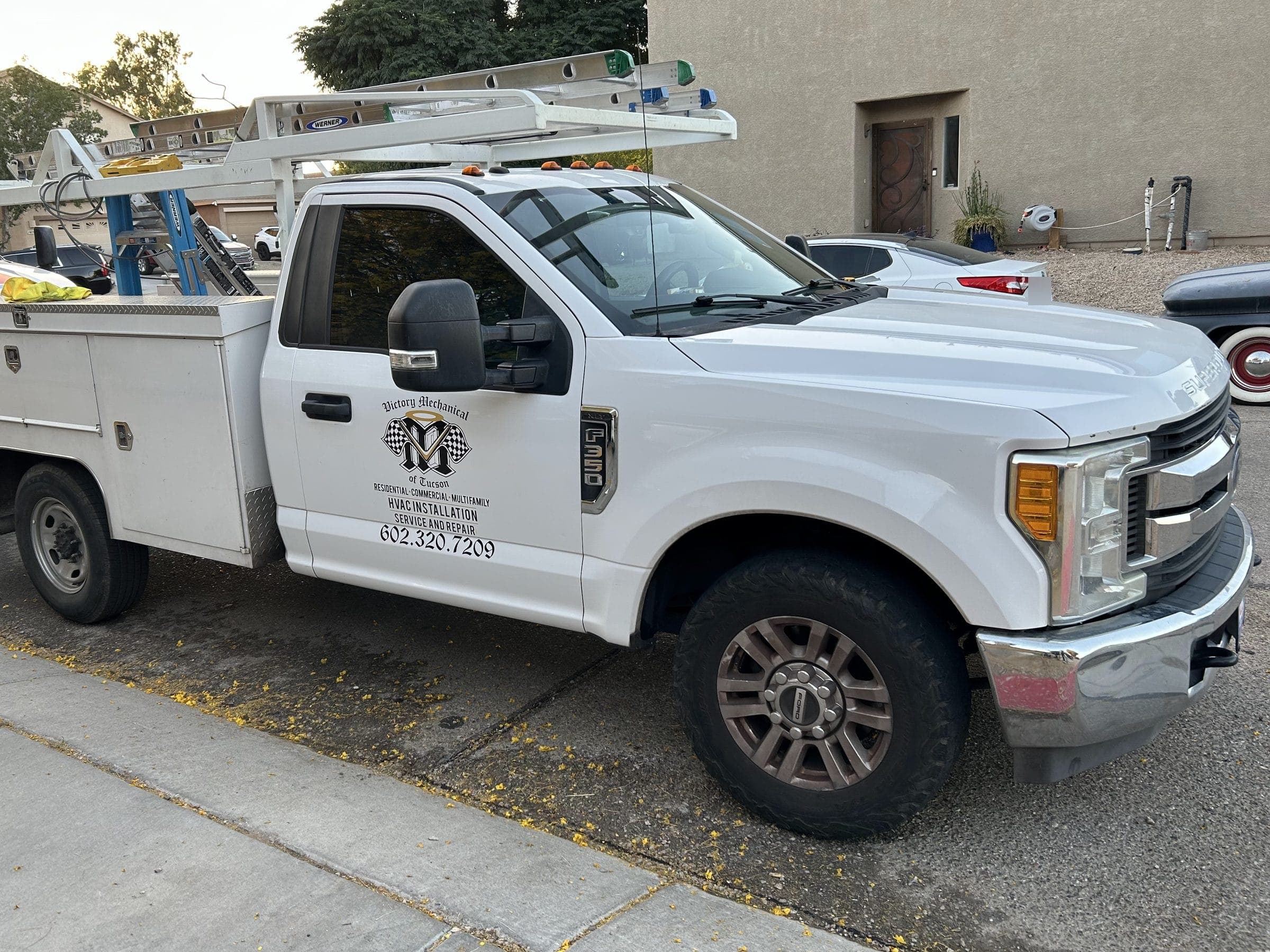 Victory Mechanical service truck with the company logo and phone number on the door