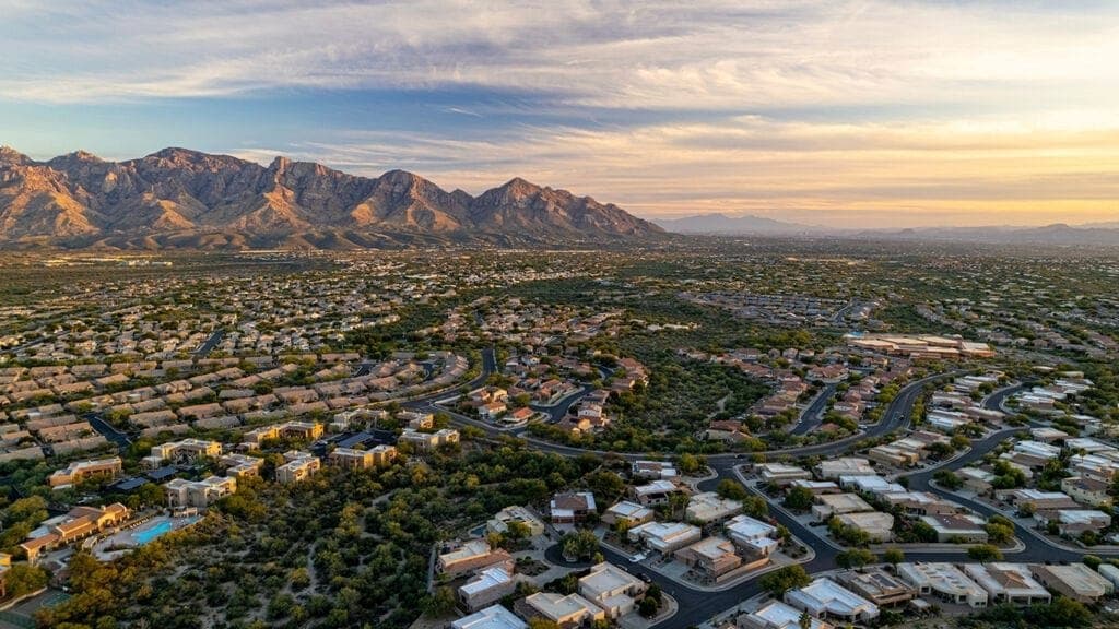 Aerial view of Oro Valley neighborhoods below the Santa Catalina Mountains at sunrise