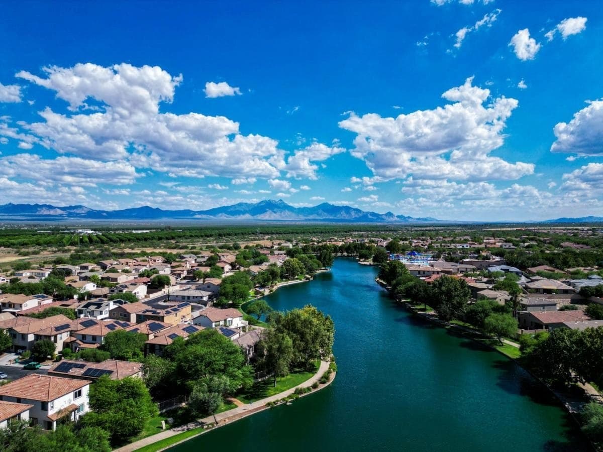 Sahuarita homes along a tree-lined lake under a blue sky