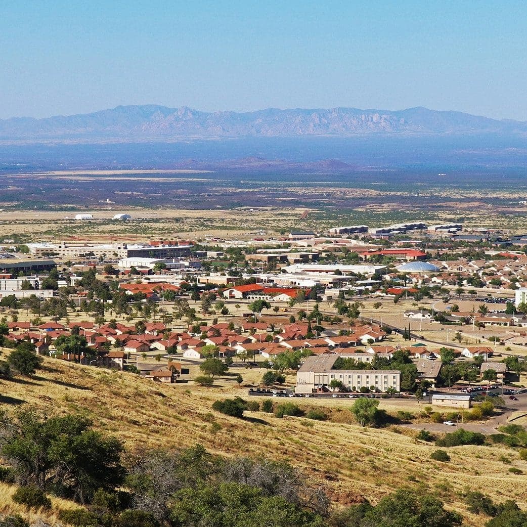 Sierra Vista seen from a grassy hillside with mountains across the valley