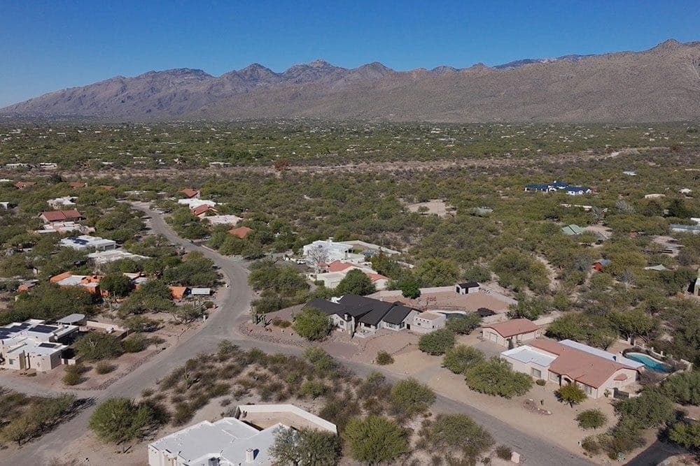 Aerial view of Tanque Verde homes on desert lots below the Rincon Mountains
