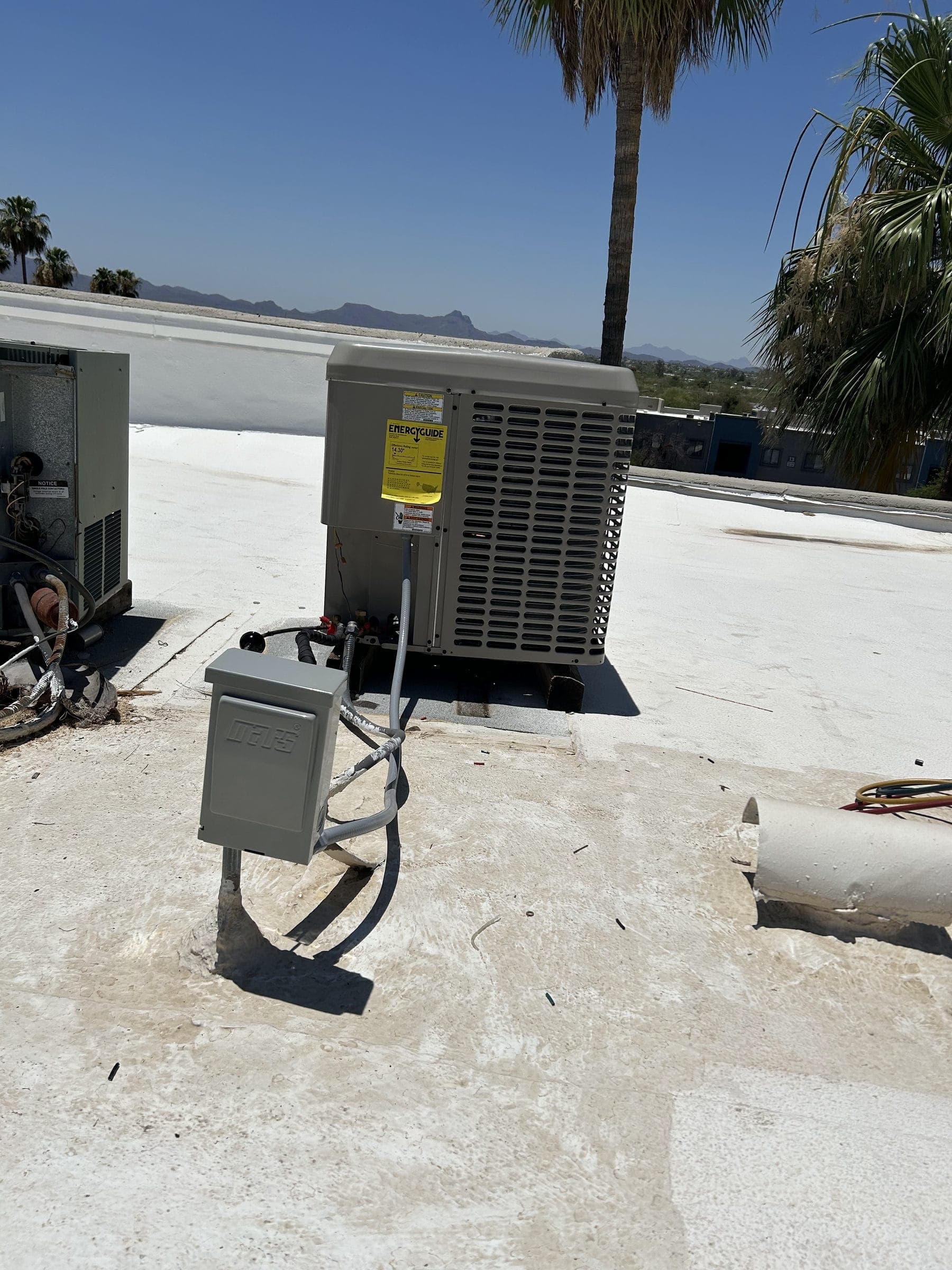 Newly installed rooftop condenser with its electrical disconnect
